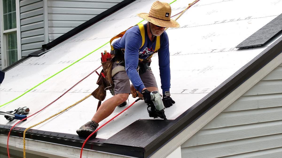 Roofing worker installing roofing material